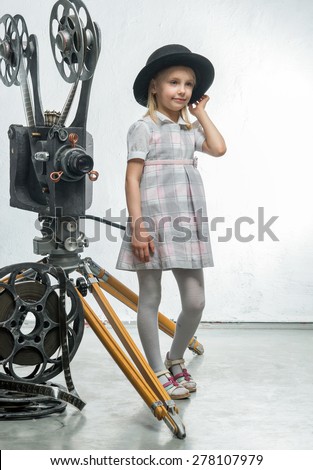 Little girl with a film projector