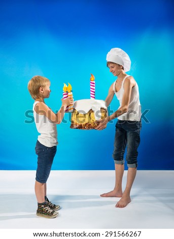 Funny boys decorate a birthday cake