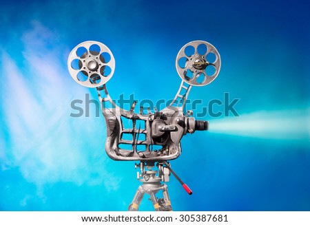 Movie projector with the film on the blue background