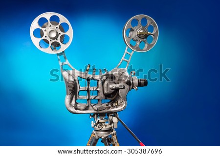 Movie projector with the film on the blue background