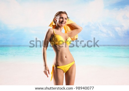 Young beautiful woman enjoying the sun on the beach