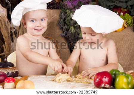 Siblings cooking in chef's hats