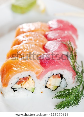 Rainbow Maki Sushi - Roll with Cucumber and Cream Cheese inside. Tuna, Salmon and Eel outside