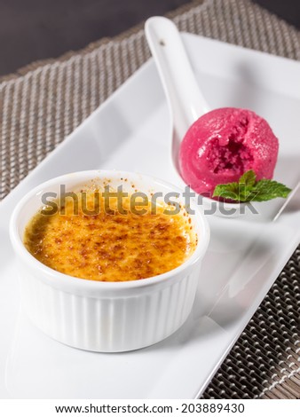 Creme brulee (cream brulee, burnt cream) with ice cream and mint