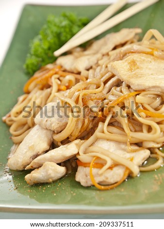 noodles with chicken and vegetables on green plate