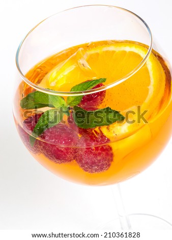 raspberry cooler cocktail with fresh berries and orange. on the white background