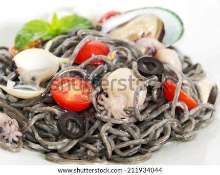 Black spaghetti with seafood and cherry tomatoes