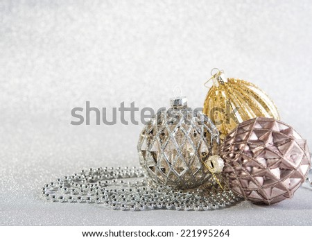 Festive beautiful christmas decoration on abstract silver glitter background. three objects