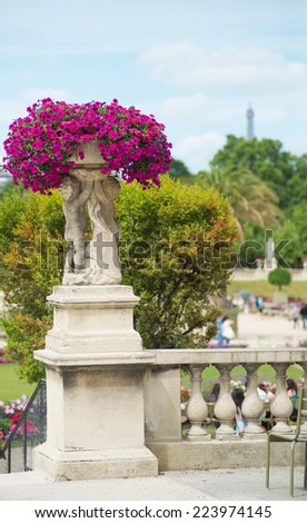 Luxembourg gardens ornamental statue, beautiful pink flowers. Paris