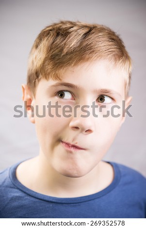 Boy in doubts, portrait isolated on white background