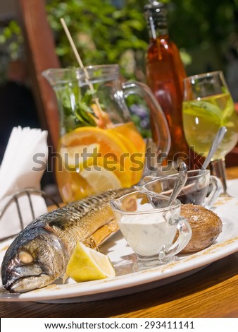 summer menu. Mackerels and vegetable salad served with lemon, and sangria