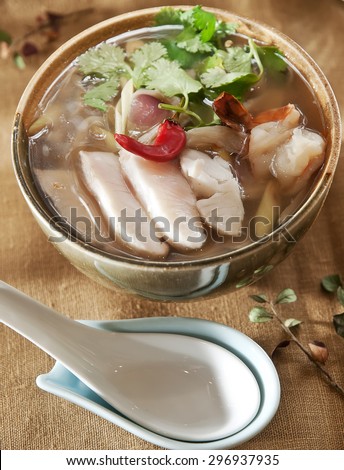 Tom Yum Goong or spicy tom yum soup with shrimp. Thai popular food menu, contained in bowl.