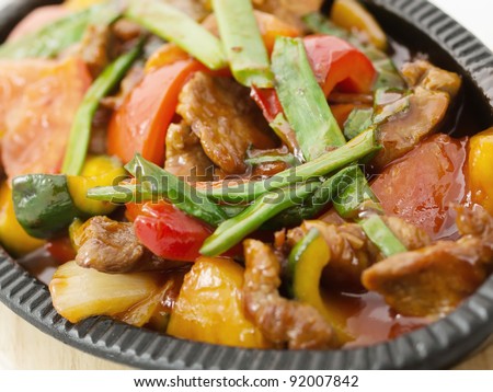 Roasted meat with vegetables on frying pan