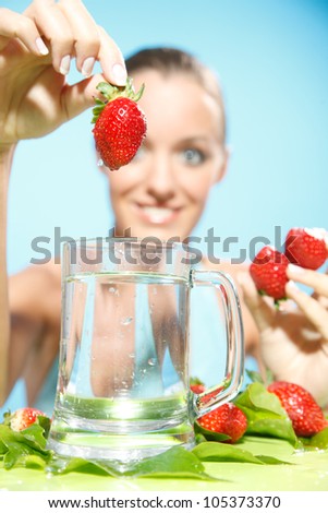 strawberry in hand in studio