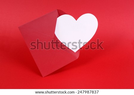 Blank white heart shape valentine card with red envelope and background.  Space for copy.