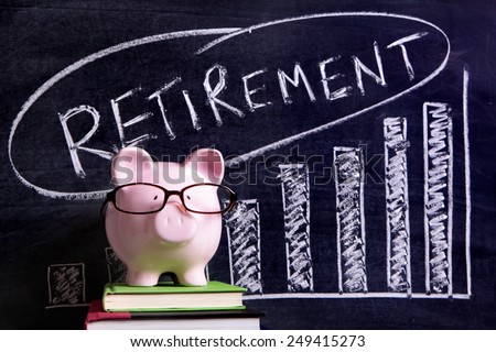 Pink piggy bank with glasses standing on books next to a blackboard with retirement plan savings message.