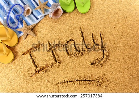 Italy beach : the word Italy written on a sandy beach background, with scuba mask, starfish and sandals