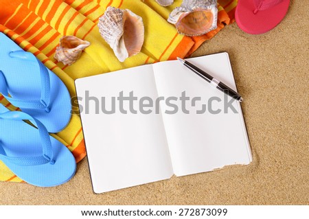 Blank writing book, pen, summer beach background, copy space.