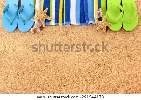 Summer border beach background, flip flops, towel, copy space.