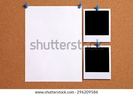 Polaroid frame photo prints, blank paper poster, pinned to cork background.  Copy space.