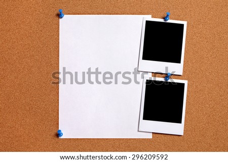 Polaroid photo prints, plain paper poster pinned to cork board.  Copy space.