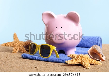 Travel money saving concept, piggybank beach vacation.