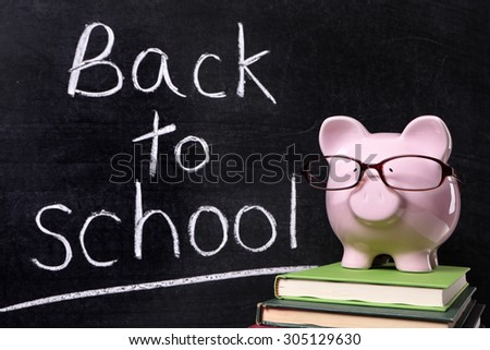 Back to school message, chalk blackboard, piggy bank