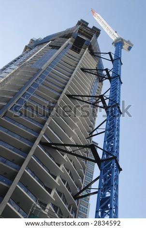 Building under construction with blue crane.  Photo taken in central Brisbane, Australia