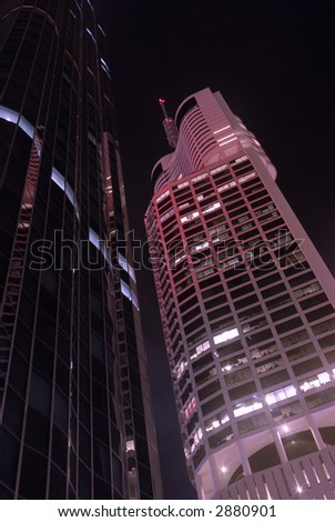Buildings at night, violet and magenta filters added to create \'other world\' effect. Note to inspector: this image has been \'coloured\' with a modest amount of violet and magenta filtering.