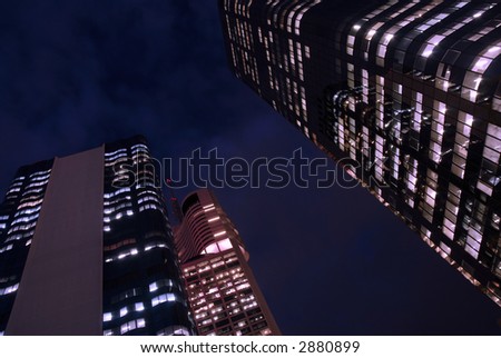Buildings at night, violet and magenta filters added to create \'other world\' effect. Note to inspector: this image has been \'coloured\' with a modest amount of violet and magenta filtering.