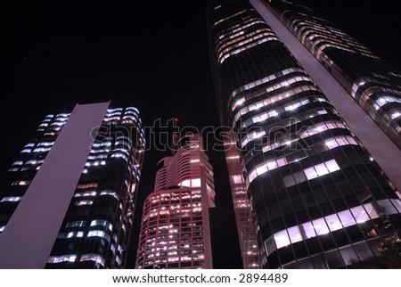 Buildings at night, violet and magenta filters added to create 'other world' effect. Note to reviewer: this image has been 'coloured' by the addition of violet and magenta filtering.