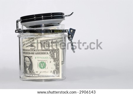 US Dollar bills, saving, glass storage jar