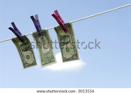 Dollar bills hanging out to dry in the sun