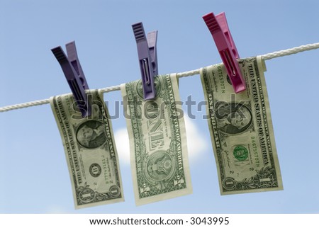 Dollar bills hanging out to dry in the sun