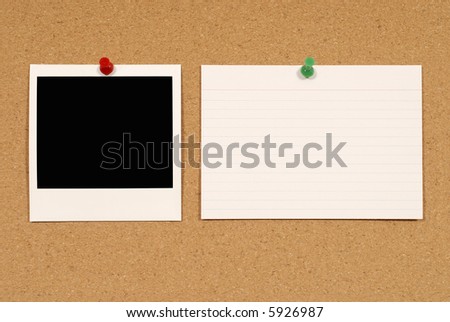 Cork notice or bulletin board with polaroid style blank instant camera photo print and white office index card. Space for copy.