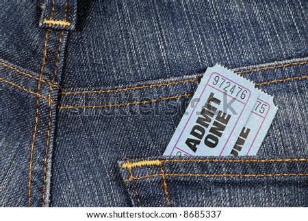 Admit one ticket : Two blue admit one movie or theater tickets in the rear pocket of denim jeans.