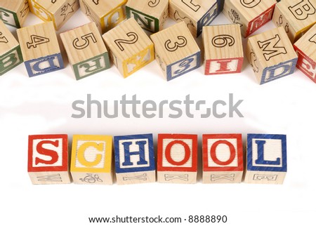 The word School with an assortment of childhood alphabet or letter blocks (please note that the blocks are naturally rustic and have numerous imperfections).
