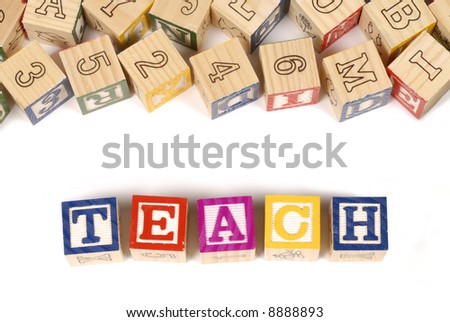 The word Teach with an assortment of childhood alphabet or letter blocks (please note that the blocks are naturally rustic and have numerous imperfections).