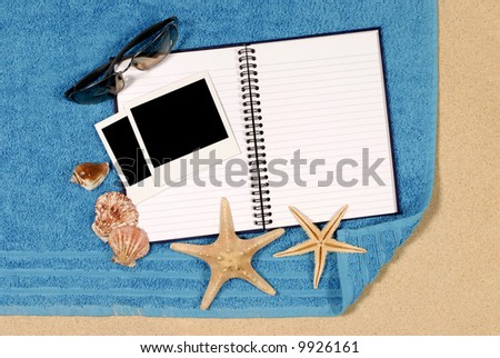 Beach scene with blank writing book and polaroid photo prints