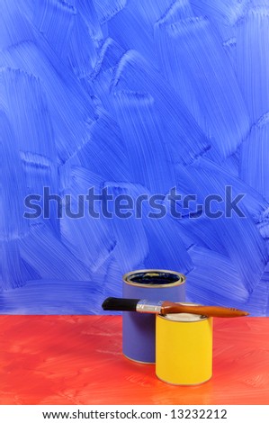 Blue painted wall with red floor and selection of paints