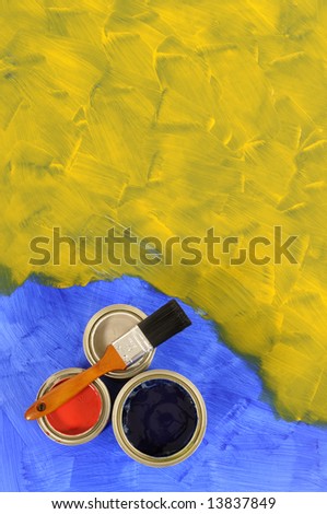 Partly finished blank blue and yellow painted floor with paint cans and paintbrush.  Space for copy.