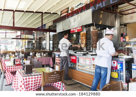 ISTANBUL, TURKEY - MARCH 14 : Chefs cutting traditional Turkish food Doner Kebab in the restaurant on March 14, 2014  in Istanbul, Turkey.