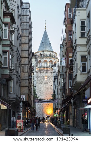 ISTANBUL, TURKEY - MAY 02: View of the famous medieval landmark Galata Tower in the old narrow street in the city center on May 02th, 2014 Istanbul, Turkey.
