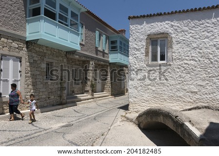 ALACATI, TURKEY -JULY 07, 2014:Alacati, well known for its architecture, vineyards and windmills is a popular summer tourist destination.