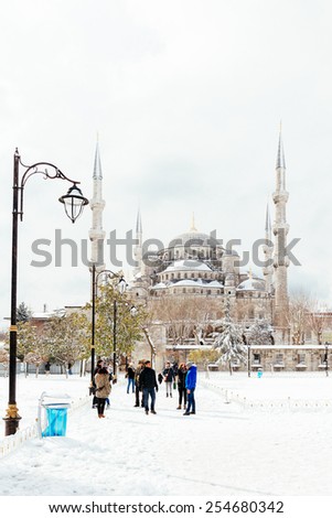 ISTANBUL, TURKEY - FEBRUARY 18, 2015:Blue mosque while snowing .istanbul winter a day.People walking in Sultanahmet District under snow.Blue mosque while snowing