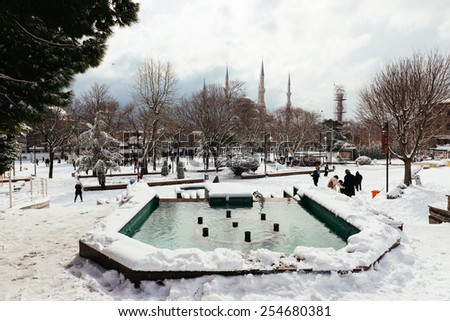 ISTANBUL, TURKEY - FEBRUARY 18, 2015:Blue mosque while snowing .istanbul winter a day.People walking in Sultanahmet District under snow.Blue mosque while snowing