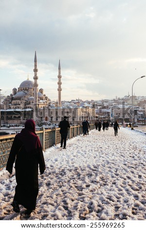 ISTANBUL, TURKEY - FEBRUARY 19, 2015:  istanbul winter a day.Turkish people walking in Eminonu district on a snowy day