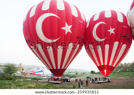 NEVSEHIR, TURKEY - MAY 08, 2012:Ground Crews torch the flame and heat up the balloon to inflate Hot Air Balloon before launching.