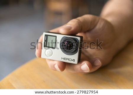 ISTANBUL, TURKEY - MAY 19 ,2015:Man holding Gopro Hero 4.Gopro action camera in hand.Shot of GoPro Hero 4 Black.It is a compact, lightweight personal camera manufactured by GoPro Inc.