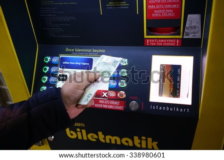 ISTANBUL, TURKEY - NOVEMBER 14, 2015:Turkish man  paying at ticket machine in a metro station.